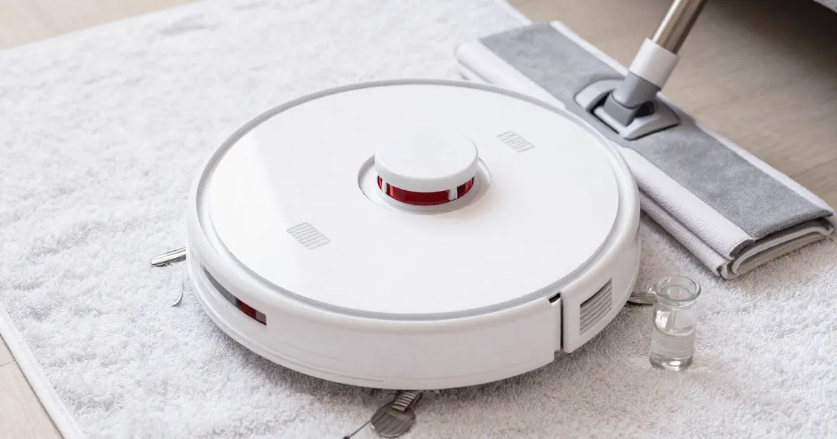 Illustration of a generic robot vacuum mop on a towel with a glass of water nearby