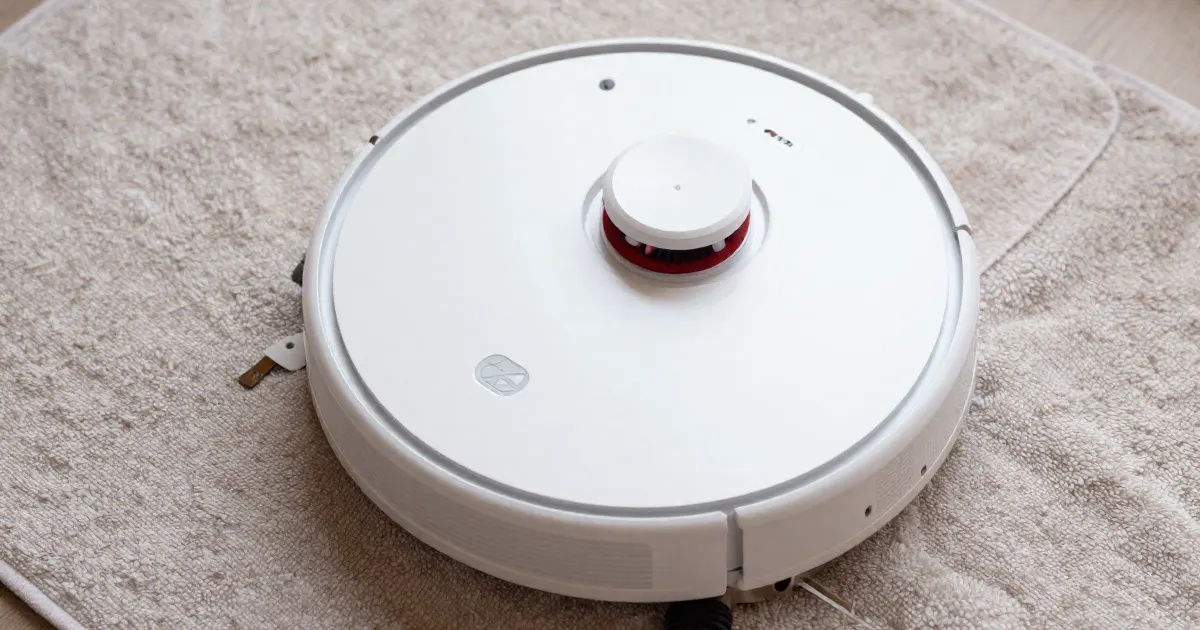 Illustration of a generic white robot vacuum seen from above on a towel